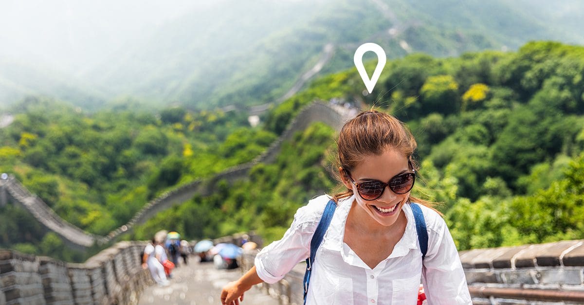 Woman taking a bucket list trip booked through arrivia's employee loyalty and rewards platform is hiking the great wall of China