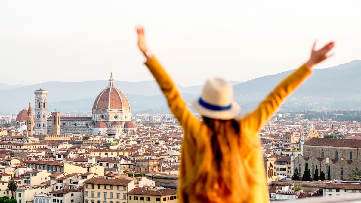 A woman standing in an Italian city available through diversifying travel rewards programs.